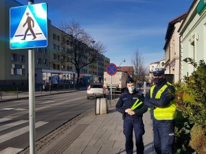 Policjantka i Policjant z odblaskami, stoją przy przejściu dla pieszych