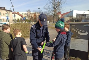 Policjantka rozdaje odblaski