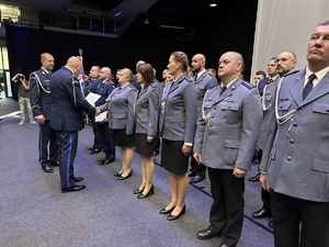 na zdjęciu komendant wojewódzki wręcza policjantom akt mianowania